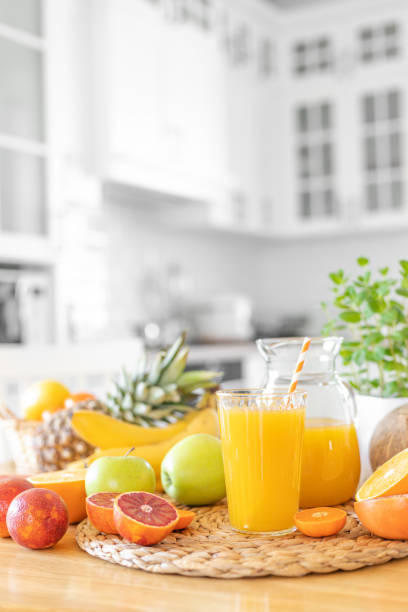 istock Multifruit juice and fresh fruit on table on kitchen background closeup 1137026564