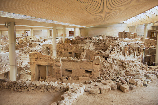 Akrotiri, Greece - August 01, 2012: Ruins of the ancient buildings from the Minoan Bronze Age at the archaeological site in Akrotiri, Greece.