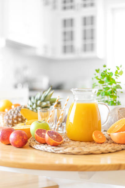 istock Multifruit juice and fresh fruit on table on kitchen background closeup 1137027390
