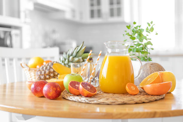 istock Multifruit juice and fresh fruit on table on kitchen background closeup 1137027403
