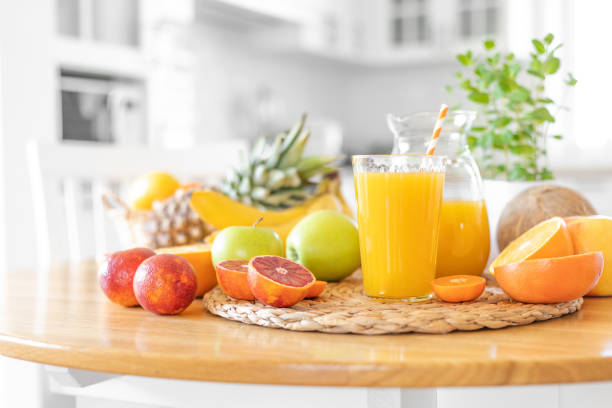 istock Multifruit juice and fresh fruit on table on kitchen background closeup 1137027536