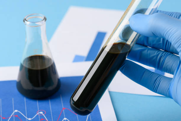 Lab test crude oil in vial in scientist hand stock photo