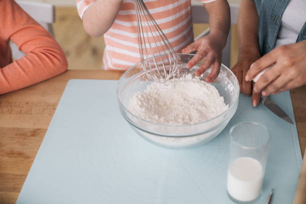 istock High angle of girl holding whisk while mixing flour in kitchen 1137028572