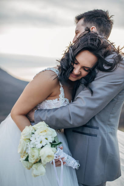 istock Young newlywed couple hugging in nature 1137028975