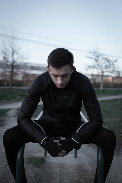 Exhausted man taking a break of exercising