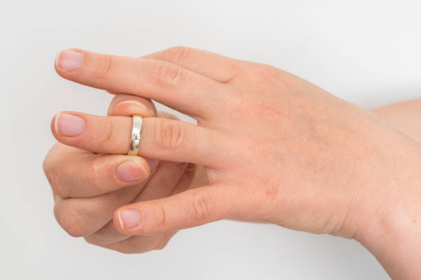 istock Woman take off wedding ring 1137029679