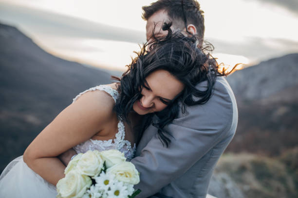 istock Newlywed couple hugging in nature 1137029709