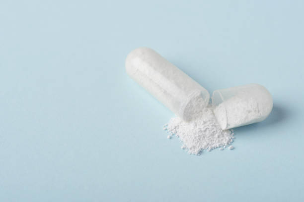 istock Open medical drug pill with white powder macro 1137030132