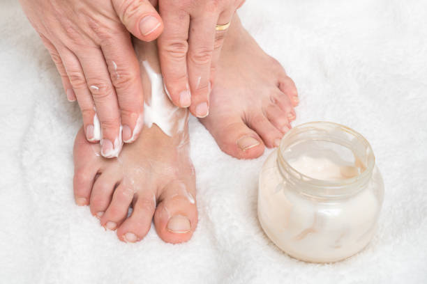 istock Woman applying moisturizer cream on her feet 1137030144