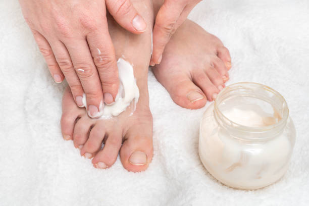 istock Woman applying moisturizer cream on her feet 1137030162