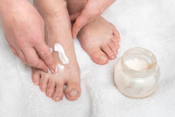 istock Woman applying moisturizer cream on her feet 1137030177
