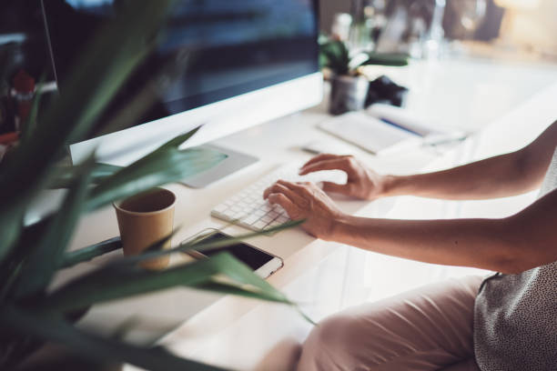 istock Female hands typing on desktop computer keyboard in modern working place at coworking office.Blurred background. 1137030314