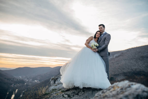 istock Happy newlywed couple hugging on mountain 1137030353