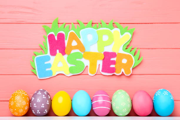 istock Colorful eggs with text Happy Easter on wooden background 1137030886
