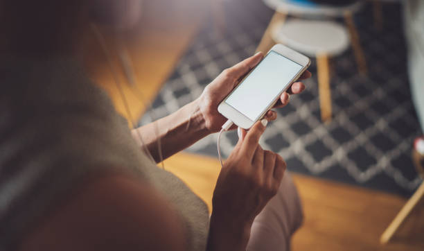 istock Female hands using mobile phone at sunny day in workplace.Horizontal. Blurred background. 1137030995