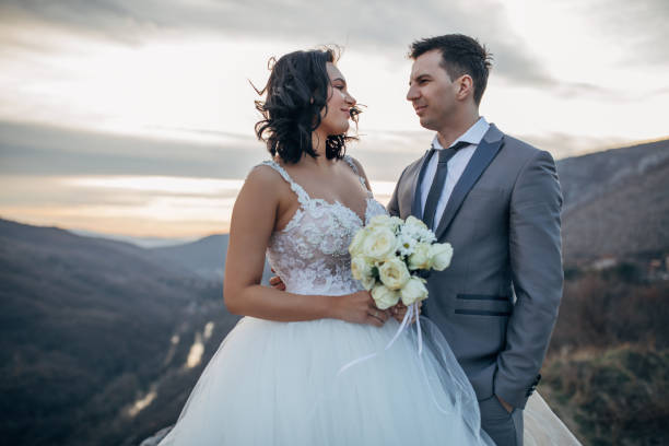 istock Happy married couple standing on mountain 1137031697