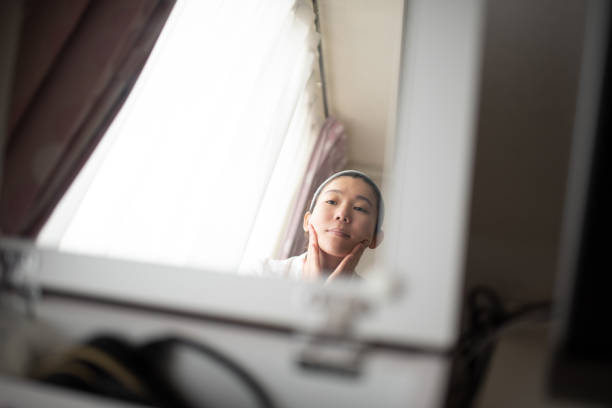 istock Woman putting on makeup 1137032657