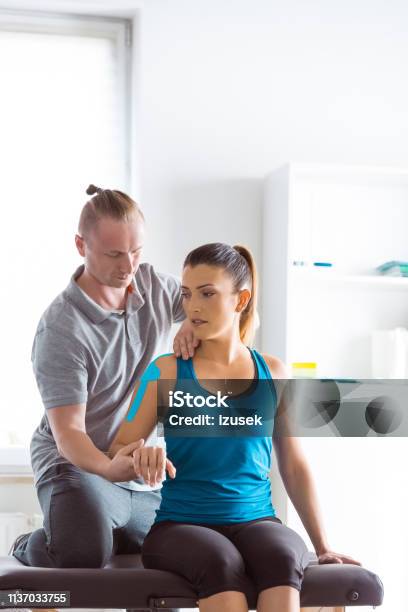 Physiotherapist Massaging Young Woman Stock Photo - Download Image Now - Physical Therapy, Females, Physical Therapist