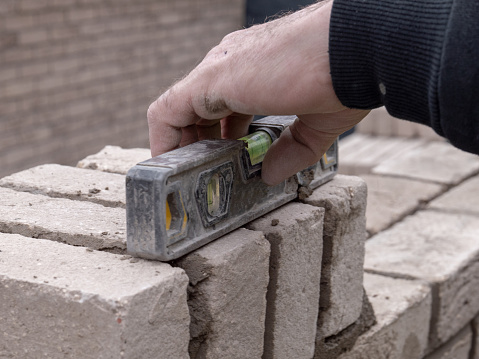Brick Level A Bricklayer Using A Spirit Level While Building A Brick Wall Stock ...