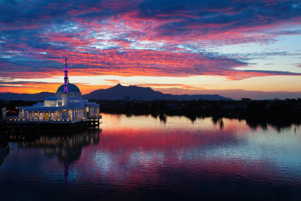 istock Scenic view of floating mosque on river with sunset background 1137035162