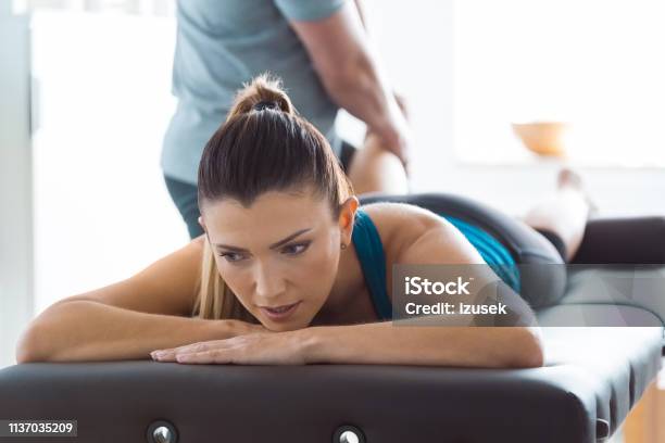 Physiotherapist Massaging Womans Leg Stock Photo - Download Image Now - Adult, Adults Only, Alternative Therapy