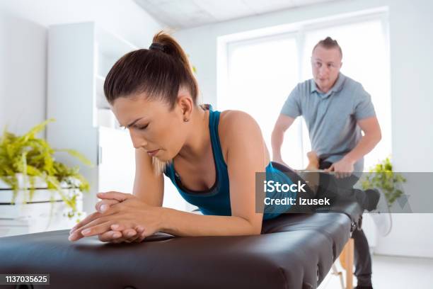 Physiotherapist Massaging Womans Leg Using Tools Stock Photo - Download Image Now - Adult, Adults Only, Alternative Therapy