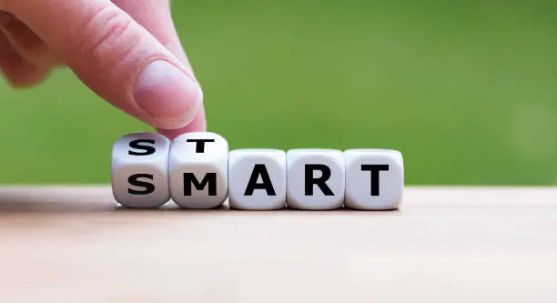 Hand turns dice and changes the word "start" to "smart".