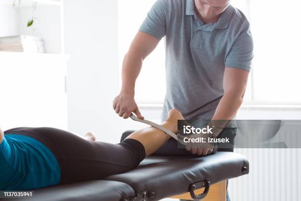 Physiotherapist Massaging Womans Leg Using Tools Stock Photo - Download Image Now - Physical Therapist, Work Tool, Metal