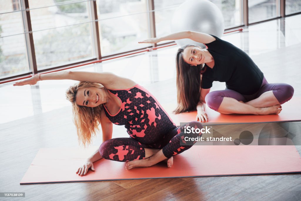 Concept of Yoga and Fitness Pregnancy. Portrait of a young model of pregnant yoga that is being developed indoors. Concept of Yoga and Fitness Pregnancy. Portrait of a young model of pregnant yoga that is being developed indoors Abdomen Stock Photo