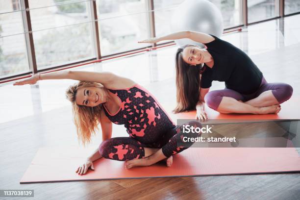 Concept Of Yoga And Fitness Pregnancy Portrait Of A Young Model Of Pregnant Yoga That Is Being Developed Indoors Stock Photo - Download Image Now