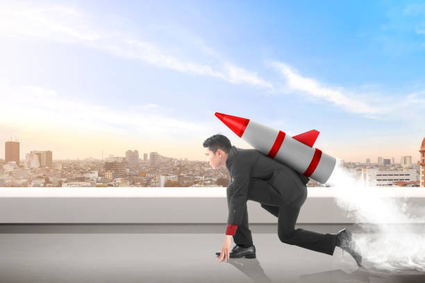 istock Young asian businessman on the rooftop with rocket ready to fly 1137038248