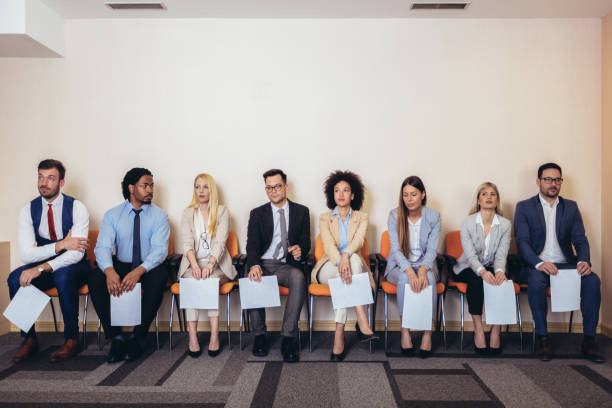 Photo of candidates waiting for a job interview. Photo of candidates waiting for a job interview. Selective focus job interview stock pictures, royalty-free photos & images