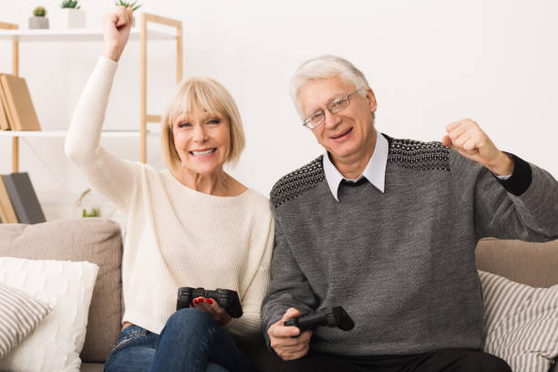 istock Elderly couple playing video games, celebrating victory 1137039689