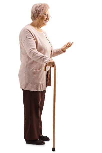 istock Senior lady standing with a cane and gesturing with a hand 1137039988