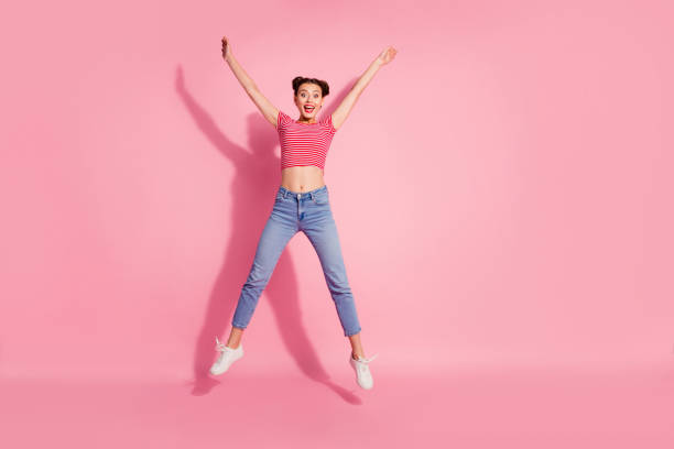 Full length body size photo yelling beautiful she her lady pomade lips jump high star shape best big great win fan wear casual jeans denim striped red white t-shirt sit floor isolated pink background Full length body size photo yelling beautiful she her lady pomade lips jump high star shape best big great win fan wear casual jeans denim striped red white t-shirt sit floor isolated pink background. stomach knot stock pictures, royalty-free photos & images