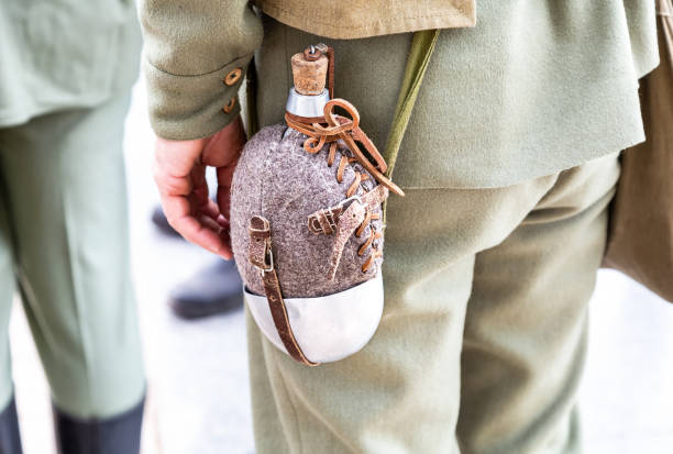istock Vintage military flask hangs on a belt from a soldier 1137040223