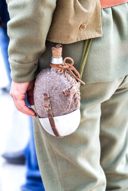 istock Vintage military flask hangs on a belt from a soldier 1137040224