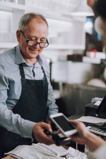 istock Shop owner using NFC technology to accept payment from customer 1137040753