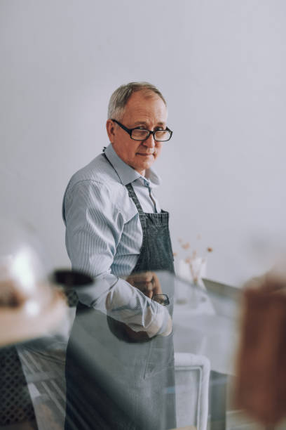 istock Elderly man in glasses standing against white background 1137040810