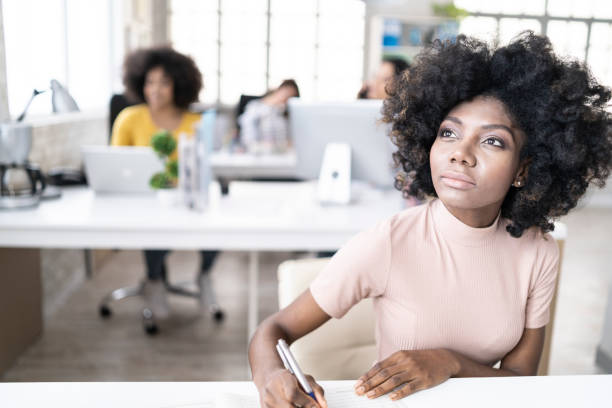 istock African woman writing and thinking 1137040819