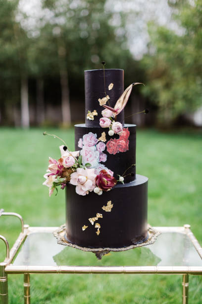 istock Black wedding cake with flowers 1137041924