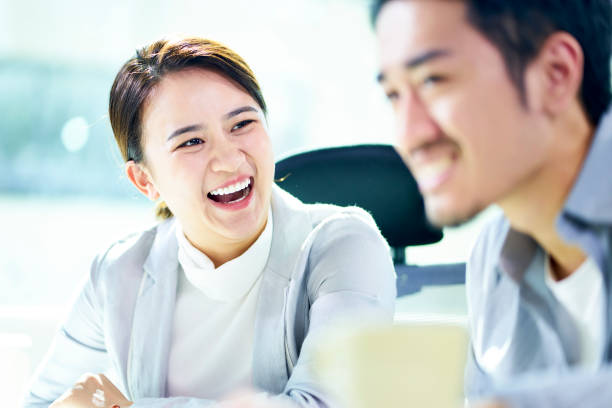 istock two asian business people working together in office 1137042405