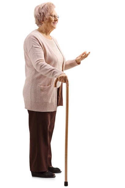 istock Elderly woman standing with a cane and gesturing with a hand 1137042544