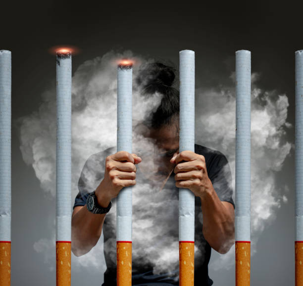 A serious man caught in The Cigarette jail. stock photo