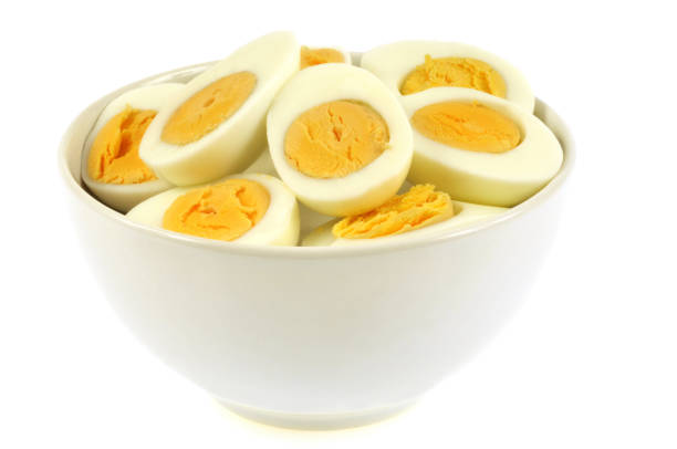 istock Bowl of hard boiled eggs cut in half on a white background 1137043790