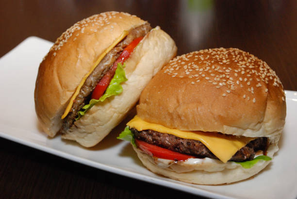 istock Two burgers with cutlet and cheese on the white plate 1137043873