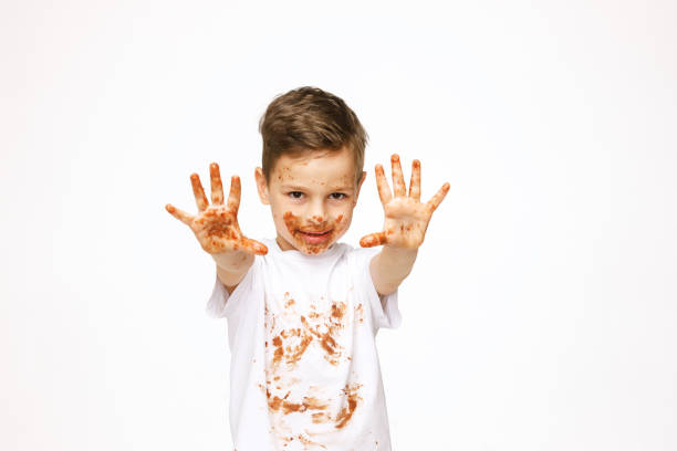 istock little boy with face and hands in chocolate 1137043888