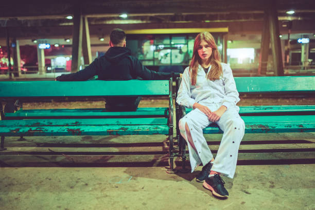 Young couple posing on a railroad station