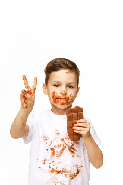 istock little boy with face and hands in chocolate 1137044285