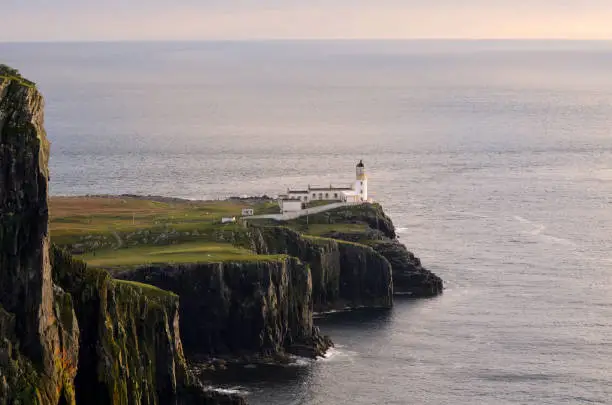 Scenic views of Neist Point Lighthouse at dusk in Scotland.